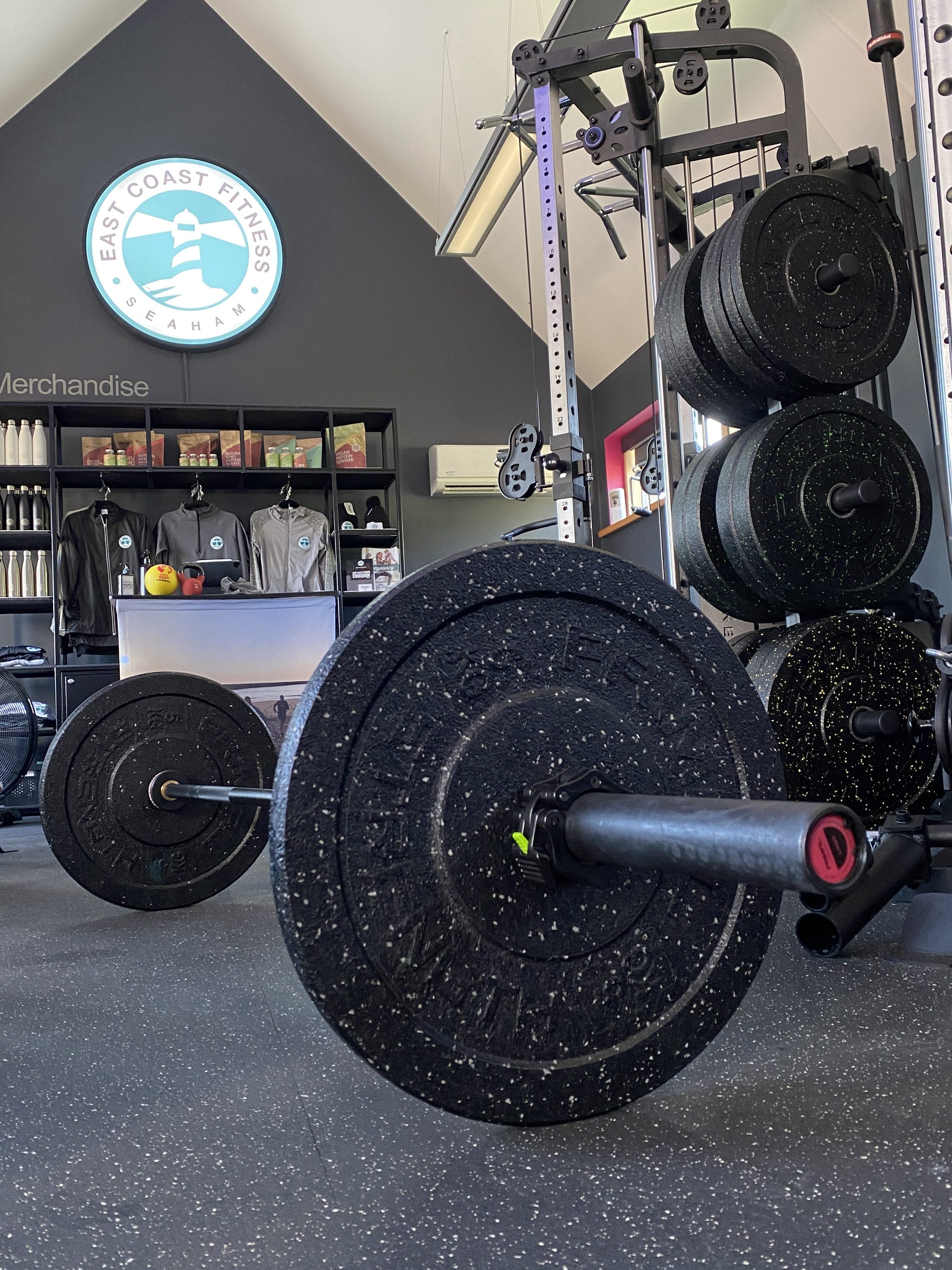 Interior view of East Coast Fitness gym showing workout equipment and merchandise display.